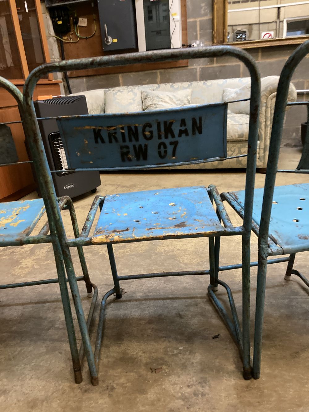 Four painted metal stacking chairs